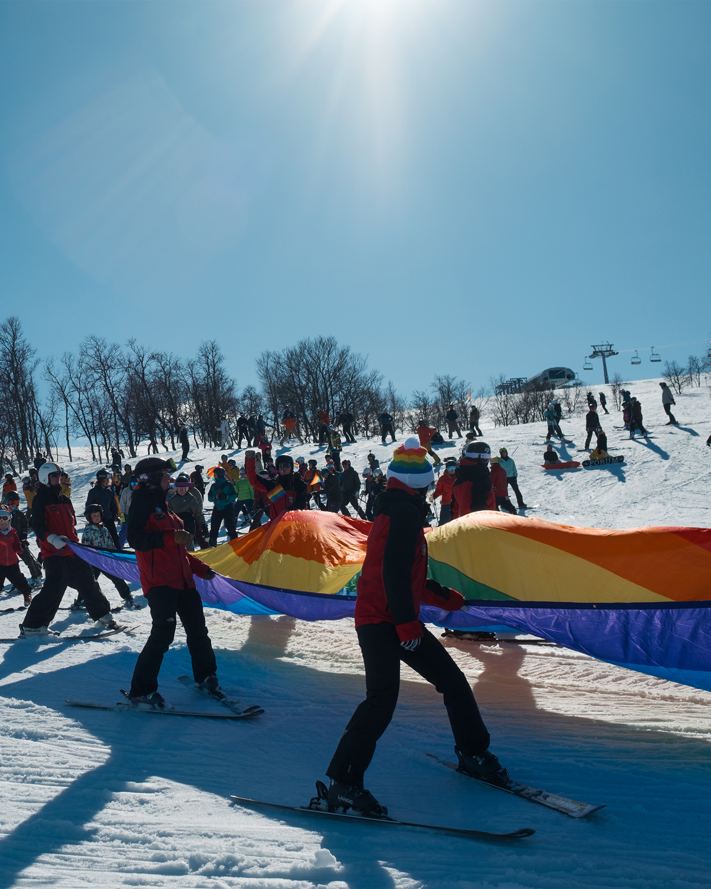 People skiing with Pride flag.